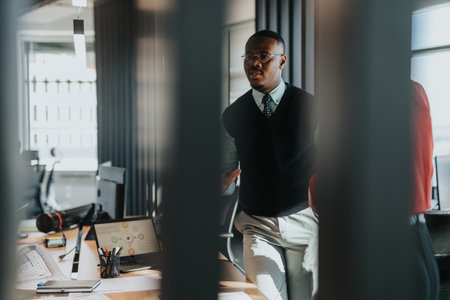 Diverse business colleagues in a modern office brainstorming and discussing project documents.の写真素材