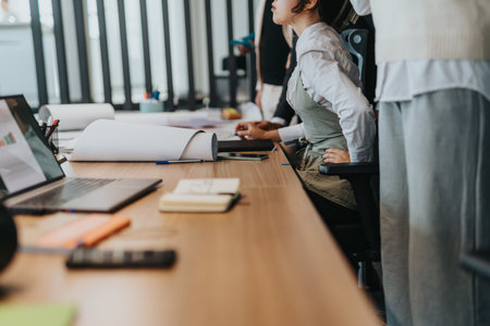 Multiracial business team discussing documents in modern office settingの写真素材