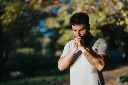 Thoughtful man in outdoor setting contemplating under sunlight