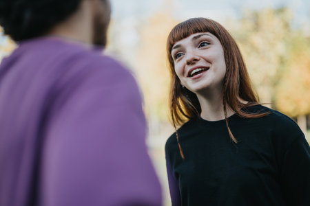 Young couple enjoying a cheerful conversation outdoorsの写真素材