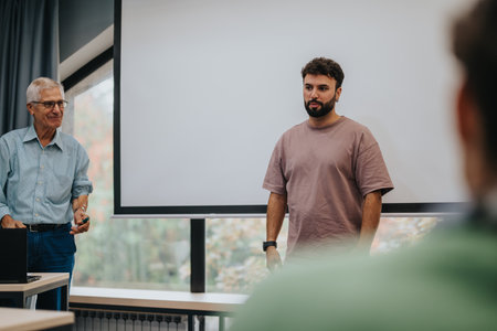 Young student presenting project with teachers guidance in classroomの写真素材