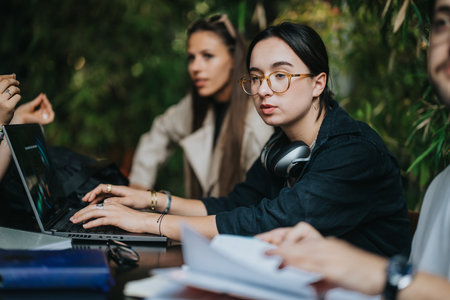 High school friends studying together in a cozy coffee shop environmentの写真素材