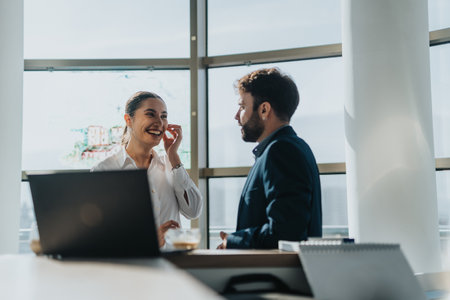 Colleagues conversing in a modern office spaceの写真素材