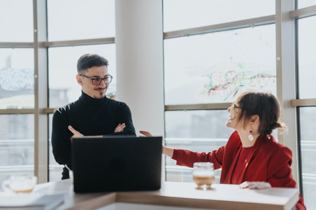 Business colleagues discussing in a modern office settingの写真素材