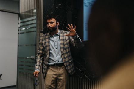 Business professional giving a late night presentation in modern officeの写真素材