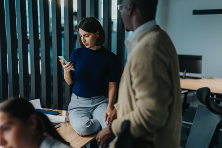 Multiracial colleagues discussing innovative ideas in modern office settingの写真素材