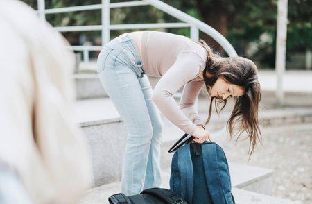 Young female student preparing for study session outdoors in the cityの写真素材