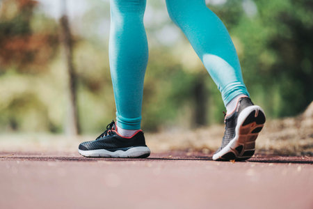 Close-up of athletic shoes during a walk in the parkの写真素材