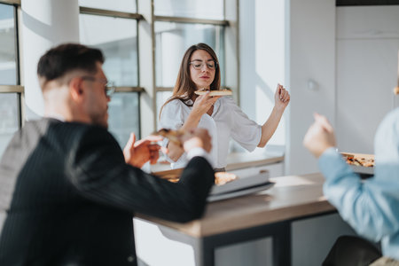Modern office employees enjoying a casual lunch break togetherの写真素材