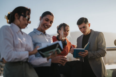 Diverse business team collaborating on rooftop at sunset