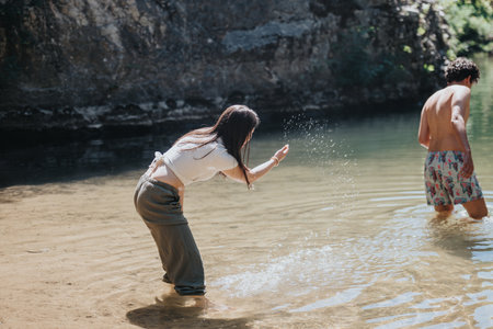 Young couple enjoying a playful day at a scenic river