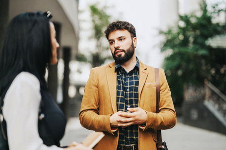 Confident business professionals engaging in outdoor conversation