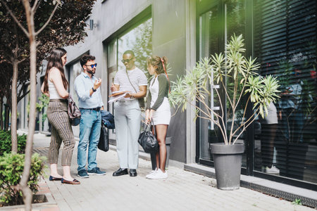 Young people discussing business ideas in an outdoor urban setting