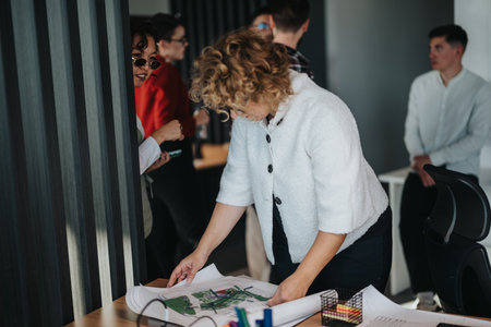 Multicultural business team collaborating on project in modern officeの写真素材