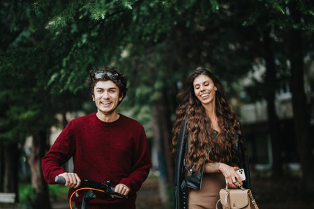 Cheerful friends enjoying a walk through the park on a sunny dayの写真素材