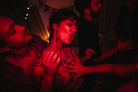 Young adults celebrating at a vibrant birthday partyの写真素材