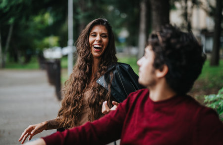 Joyful friends laughing together in a park settingの写真素材