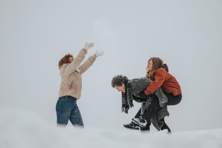 Three friends enjoying a fun winter day outdoors, playing in the snow together