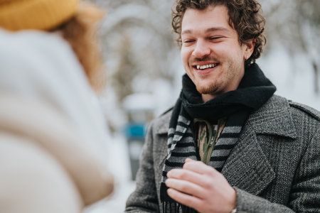 Two friends enjoying a cheerful moment outdoors on a winter dayの写真素材