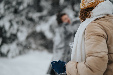 Two individuals enjoying a playful snow experience in a winter wonderland
