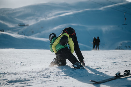 Children skiing on snowy mountain slopes under guidance of instructor in winterの写真素材