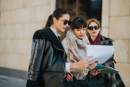 Group of women collaborating on a project plan outdoorsの写真素材