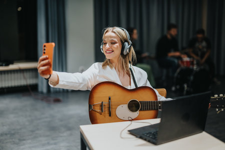 Woman Playing Guitar and Taking Selfie During Studio Music Session