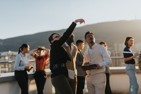 A group of business colleagues stand on a rooftop terrace brainstorming ideas.
