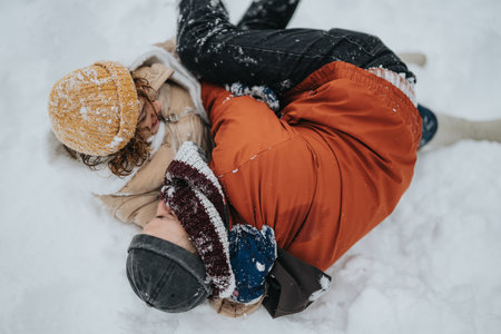 Happy Family Playing in the Snow During Winter Outdoorsの写真素材