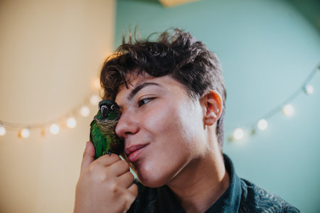 Young girl joyfully playing with her pet parrot indoors