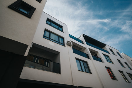 Modern residential apartment building under a clear blue sky during daytime