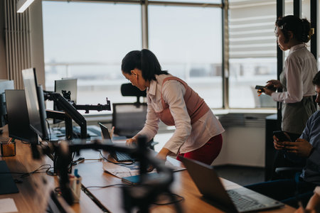 Team of business employees collaborating in a modern office spaceの写真素材