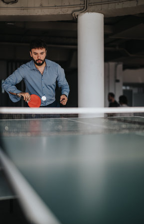 Business worker playing table tennis for office recreationの写真素材