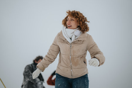 Woman Enjoying the Winter Outdoors Dressed in Warm Clothingの写真素材