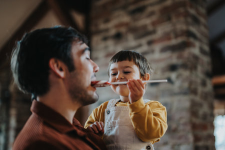 Father and child engaged in playful bonding at homeの写真素材