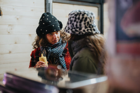 Friends sharing a moment together during a winter holiday outingの写真素材