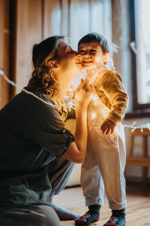 Mother and child sharing a warm moment surrounded by decorative lights indoors