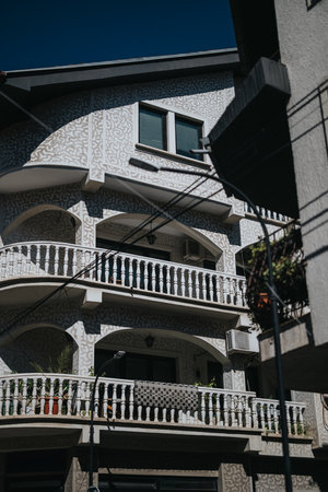 Elegant residential building exterior with decorative facade and arched balconiesの写真素材