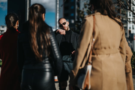 Business meeting outdoors with a man explaining to colleagues in urban settingの写真素材