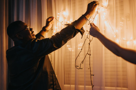 Decorating a Room with String Lights for a Special Celebrationの写真素材