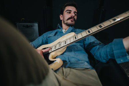 Man playing bass guitar in a music studio session