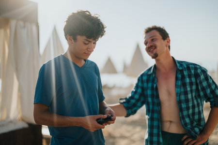 Two friends enjoy a casual moment outdoors at a sunny beach setting