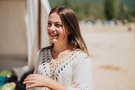 Smiling woman outdoors enjoying the sunlight in a casual summer setting