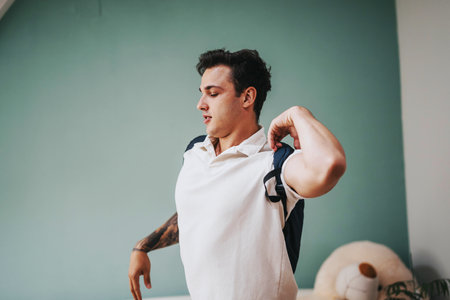 Young student putting on backpack in a casual setting