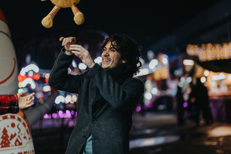 Man enjoying festive winter night with friends at an outdoor celebrationの写真素材