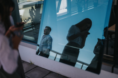 Business people in an office reflection with smart phone usageの写真素材
