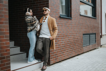 Young couple enjoying an outdoor urban setting in stylish outfitsの写真素材