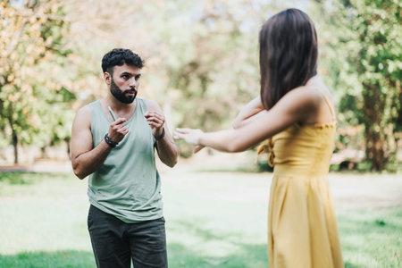 Young friends engaged in a conversation at a sunny park