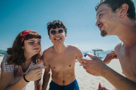 Three friends having fun together during summertime at the beach
