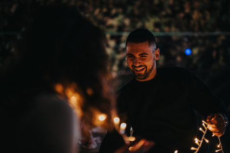Smiling Friends with Twinkling String Lights During Evening Outdoor Gathering